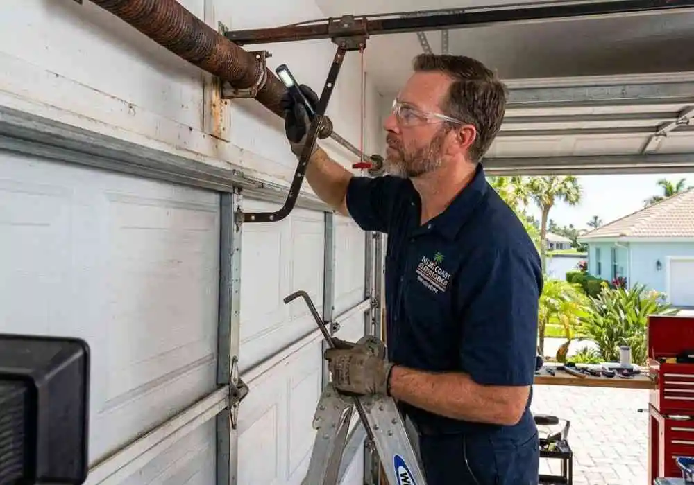 Garage Door Repair Ormond Beach FL 27 Garage door technician inspecting corroded torsion spring in Palm Coast FL